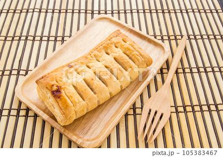 Pineapple pie in wooden plate on wooden background Pineapple pie in wooden plate on wooden background 105383467