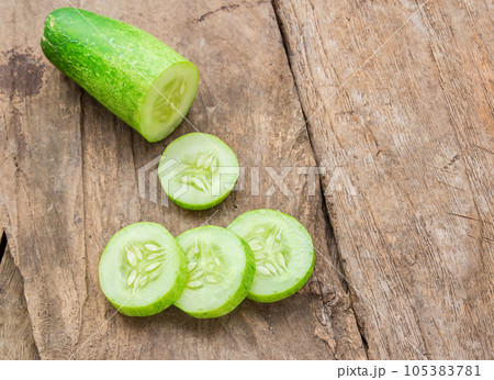 Fresh cucumber on wooden table 105383781
