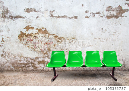 Green chair on the floor with grunge background Green chair on the floor with grunge background 105383787