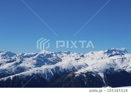Mountain with snow. Alps. Switzerland. Panoramic view of the Snowy Alps and blue sky around the Titlis mountain. French Alps. Alpine mountains. Descent peaks on the Austrian snow slopes. ski slopes. Mountain with snow. Alps. Switzerland. Panoramic view of the Snowy Alps and blue sky around the Titlis mountain. French Alps. Alpine mountains. Descent peaks on the Austrian snow slopes. ski slopes. 105385528