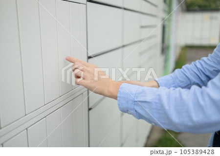 Woman client using automated self service post terminal machine or locker. Mail shipping concept Woman client using automated self service post terminal machine or locker. Mail shipping concept 105389428