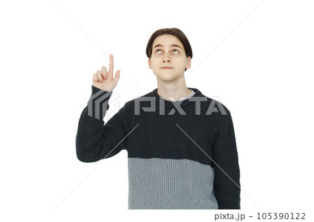Clever young man in black sweater pointing up on white background Clever young man in black sweater pointing up on white background 105390122
