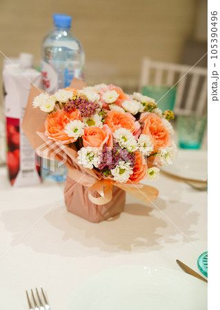 Bouquet of flowers on the served table. Bouquet of flowers on the served table. 105390496
