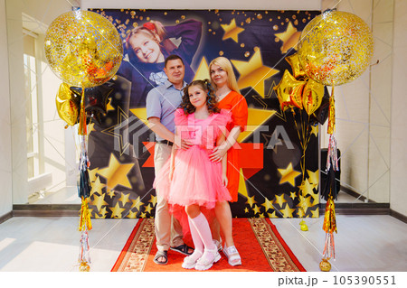 parents with Beautiful teenage daughter in a pink dress for pop star parties. parents with Beautiful teenage daughter in a pink dress for pop star parties. 105390551