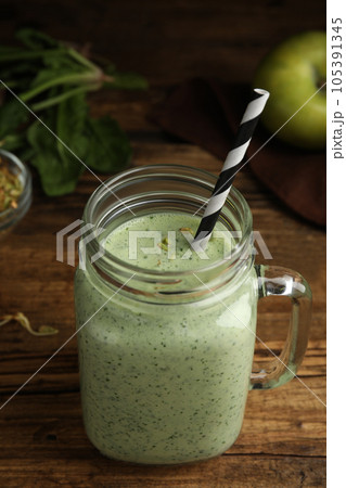 Tasty green buckwheat smoothie on wooden table 105391345