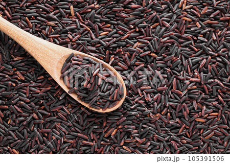 Pile of brown rice with spoon, top view. Space for text 105391506