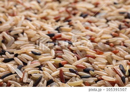 Mix of different brown rice as background, closeup Mix of different brown rice as background, closeup 105391507