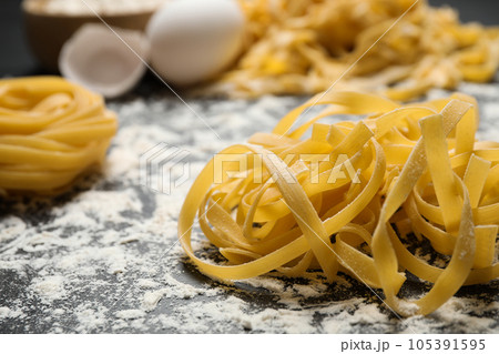 Tagliatelle pasta on grey table, closeup view 105391595
