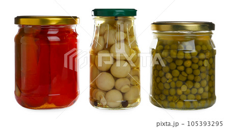 Glass jars of different pickled vegetables isolated on white 105393295