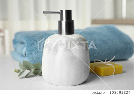 Marble dispenser, eucalyptus and soap bar on white table Marble dispenser, eucalyptus and soap bar on white table 105393824