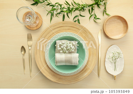 Elegant table setting with flowers and leaves, flat lay Elegant table setting with flowers and leaves, flat lay 105393849