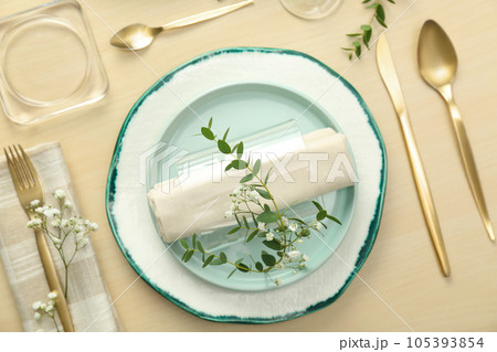 Elegant table setting with flowers and leaves, flat lay Elegant table setting with flowers and leaves, flat lay 105393854