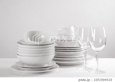 Set of clean dishes on white table Set of clean dishes on white table 105394410