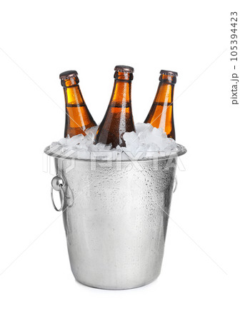 Beer in metal bucket with ice isolated on white Beer in metal bucket with ice isolated on white 105394423