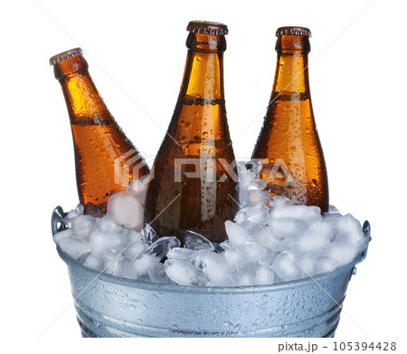 Beer in metal bucket with ice isolated on white Beer in metal bucket with ice isolated on white 105394428