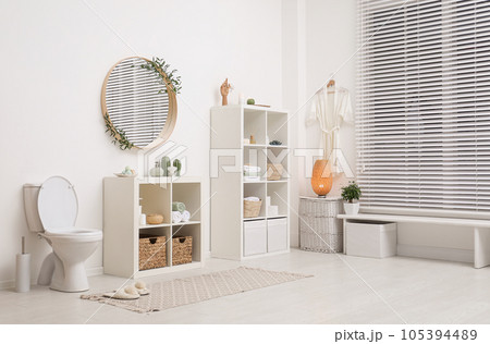 Interior of modern bathroom with round mirror Interior of modern bathroom with round mirror 105394489