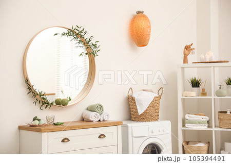Round mirror on white wall in modern bathroom Round mirror on white wall in modern bathroom 105394491
