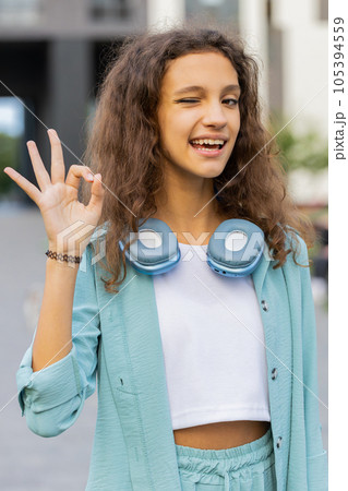 Happy cheerful child girl showing ok gesture, positive like sign, approve something good, celebrate 105394559