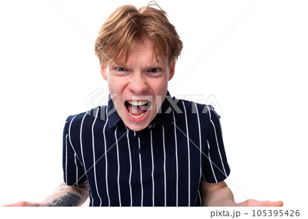 emotional 25 year old blond man in a striped polo screaming 105395426