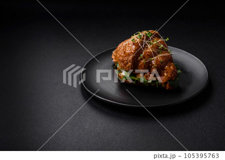 Delicious crispy croissant with salmon, lettuce, cheese and tomatoes 105395763