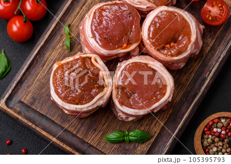 Delicious raw fresh pork or chicken meat rolls wrapped in bacon 105395793