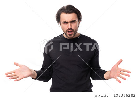 young confused pleasant brunette man in a black sweater on an isolated white background young confused pleasant brunette man in a black sweater on an isolated white background 105396282