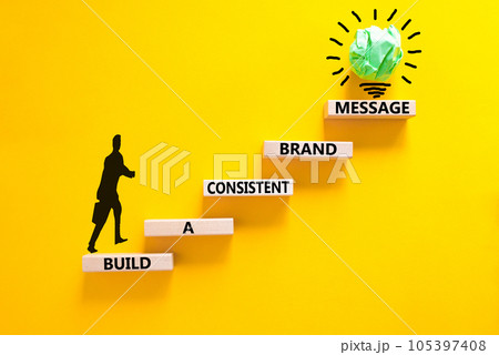 Consistent brand message symbol. Concept words build a consistent brand message on wooden blocks. Beautiful yellow background Businessman icon. Business consistent brand message concept. Copy space. Consistent brand message symbol. Concept words build a consistent brand message on wooden blocks. Beautiful yellow background Businessman icon. Business consistent brand message concept. Copy space. 105397408