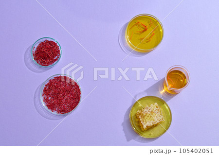 Minimal style, advertising photo for product extracted from saffron and honey on purple background. Saffron soaked in honey helps to improve the immune system and increase resistance Minimal style, advertising photo for product extracted from saffron and honey on purple background. Saffron soaked in honey helps to improve the immune system and increase resistance 105402051