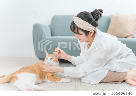 綿棒を使って猫の耳掃除をする飼い主のアジア人女性 綿棒を使って猫の耳掃除をする飼い主のアジア人女性 105406146