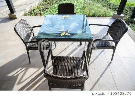 The marking on empty wooden table without nobody. Keep spaced between each chairs make separate for social distancing to avoid spreading of Covid-19. Social distance concept. The marking on empty wooden table without nobody. Keep spaced between each chairs make separate for social distancing to avoid spreading of Covid-19. Social distance concept. 105408370