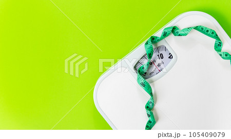 Weight loss control planning.  White scale and measuring tape for body dieting healthy life 105409079