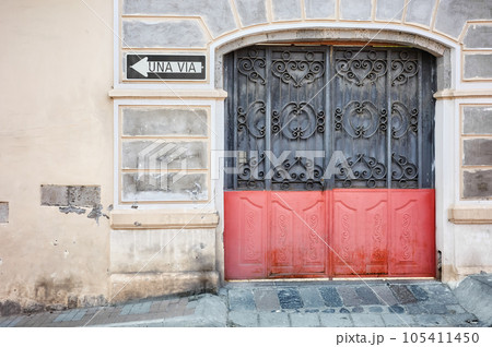 Street view of an old building facade with metal gate, architecture background, Latacunga, Ecuador. Street view of an old building facade with metal gate, architecture background, Latacunga, Ecuador. 105411450