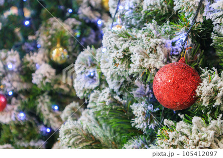 Christmas tree decorated with red ball on pine branches background Christmas tree decorated with red ball on pine branches background 105412097