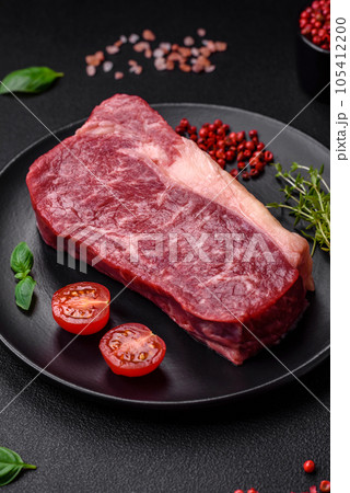 Fresh raw beef striploin steak with salt, spices and herbs Fresh raw beef striploin steak with salt, spices and herbs 105412200