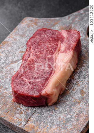 Fresh raw beef striploin steak with salt, spices and herbs Fresh raw beef striploin steak with salt, spices and herbs 105412220