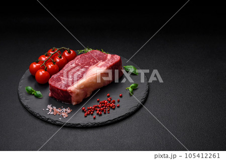 Fresh raw beef striploin steak with salt, spices and herbs Fresh raw beef striploin steak with salt, spices and herbs 105412261