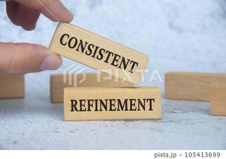 Consistent refinement text on wooden blocks. Business strategy concept. 105413699
