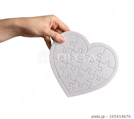 Hand holding heart puzzle isolated on white background. Donation, love, charity concept Hand holding heart puzzle isolated on white background. Donation, love, charity concept 105414670