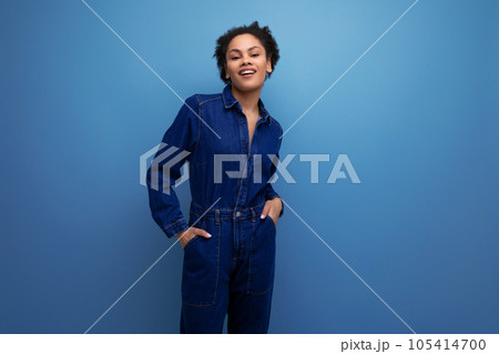 pretty brunette latin woman in blue denim suit over isolated background pretty brunette latin woman in blue denim suit over isolated background 105414700