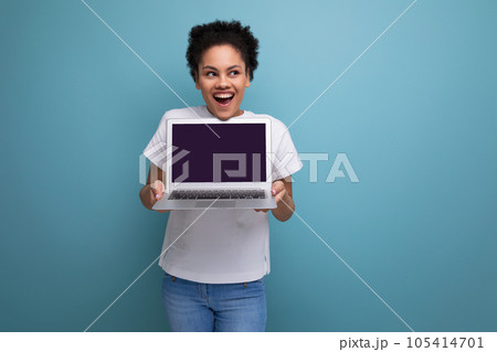 young latin brunette student woman in white t-shirt ready to present her project using laptop with young latin brunette student woman in white t-shirt ready to present her project using laptop with 105414701