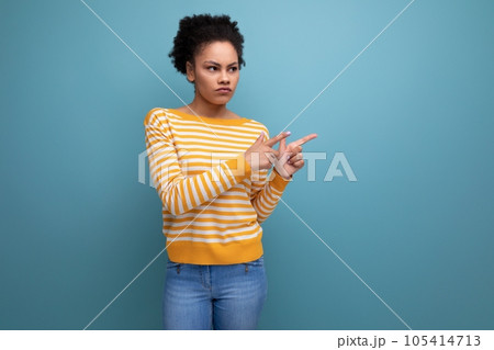 curly brunette 20s latin young woman with ponytail demonstrating a proposal on the wall on an curly brunette 20s latin young woman with ponytail demonstrating a proposal on the wall on an 105414713