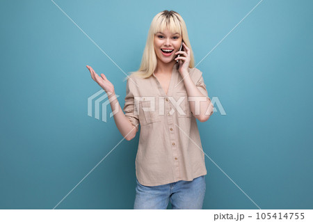 blonde european young woman talking on the phone 105414755