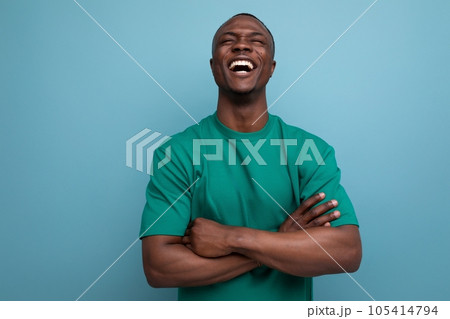 young modest american guy dressed in a basic t-shirt against the background with copy space 105414794