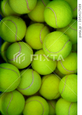 Lots of vibrant green tennis ball pattern background Lots of vibrant green tennis ball pattern background 105417589