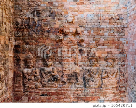 Bas-relief carved on a brick wall in the Hindu temple of Prasat Kravan. Shakti Vishnu or consort, Lakshmi, is depicted standing surrounded by praying figures. She is the highest Shakti. Bas-relief carved on a brick wall in the Hindu temple of Prasat Kravan. Shakti Vishnu or consort, Lakshmi, is depicted standing surrounded by praying figures. She is the highest Shakti. 105420711