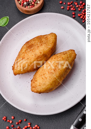 Delicious baked potato cutlet stuffed with chicken and vegetables, spices and salt 105421787