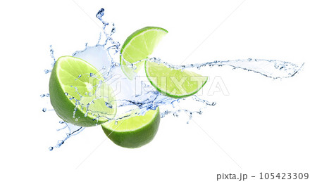 Ripe limes and splashing water on white background 105423309