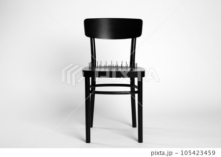 Chair with iron nails isolated on white. Hemorrhoids concept 105423459
