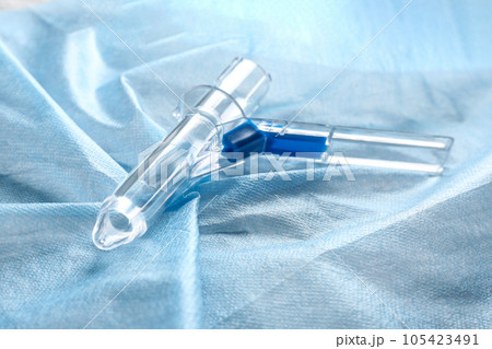 Anoscope on light blue fabric. Hemorrhoid treatment Anoscope on light blue fabric. Hemorrhoid treatment 105423491