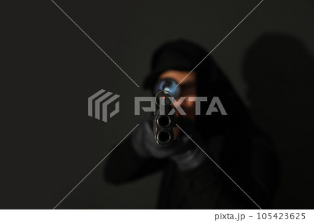 Professional killer on black background, focus on sniper rifle Professional killer on black background, focus on sniper rifle 105423625